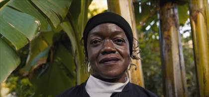 Photograph of artist Claudette Johnson standing in front of trees