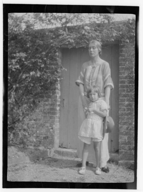 Black and white negative of Vanessa Bell standing behind Angelica Bell