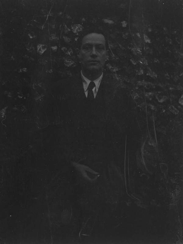 Black and white negative of Duncan Grant wearing a suit and posing in ...