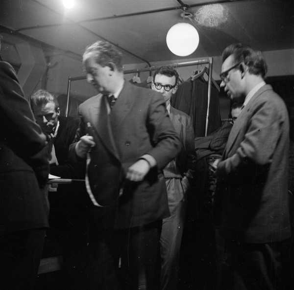 Photograph showing musicians inside a shop selling men’s clothes