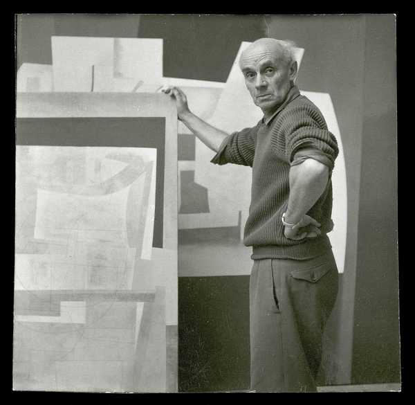 Photograph of Ben Nicholson holding one of his works in his St Ives ...