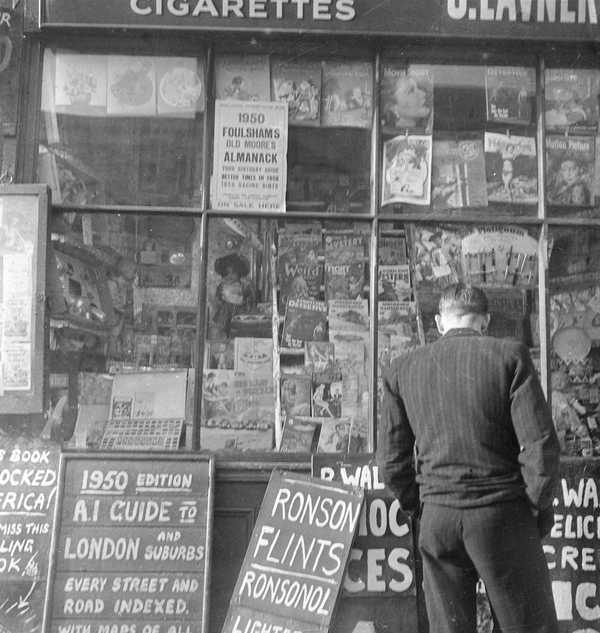 Photograph of an unidentified man looking into the window of S. Lavner ...