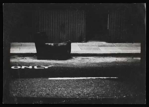 Black and white photograph of a chair on a road, from the ‘Georgiana ...