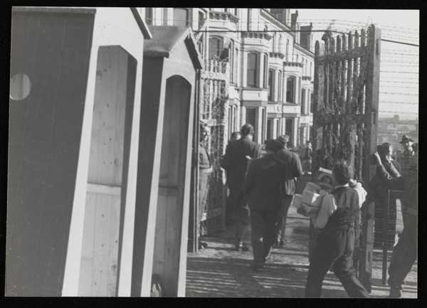 Photograph of internees carrying rations at Hutchinson Internment Camp ...