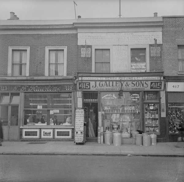 Photograph showing shop fronts of T.F Hawkins and J.Galley & Sons from