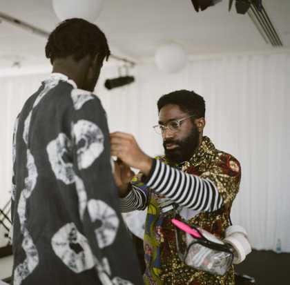 Stylist dressing a musician