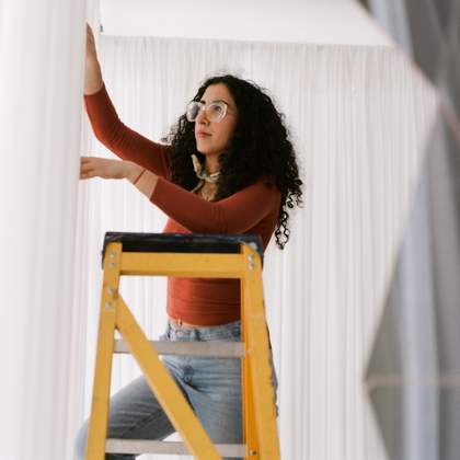 Set designer putting up some curtains