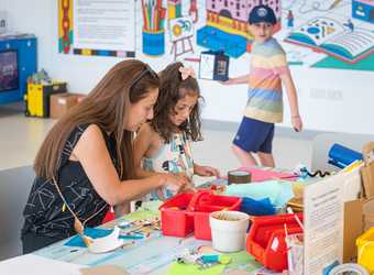 A child and parent participating in a craft activity in Tate Liverpool's studio