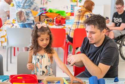 A child and parent crafting at a table in the studio at Tate Liverpool