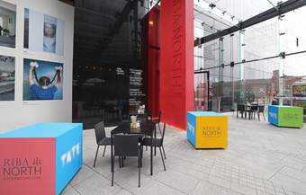 A photograph of the tables outside the entrance of Tate Liverpool + RIBA North