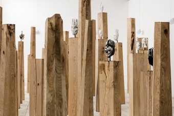 wooden plinths with masks on it
