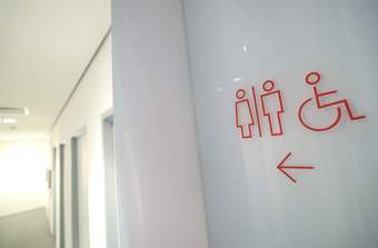 A photograph of a sign showing where the toilets are at Tate Liverpool + RIBA North