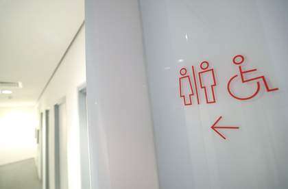 A photograph of a sign showing where the toilets are at Tate Liverpool + RIBA North