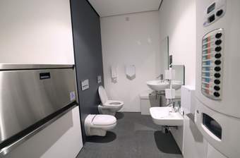 A photograph of the family toilet at Tate Liverpool + RIBA North which includes an adult toilet and smaller toilet and baby changing facilities
