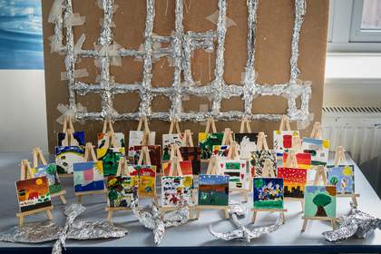A closeup image of the students’ finished paintings and birds, showing the variety of compositions and bird shapes.