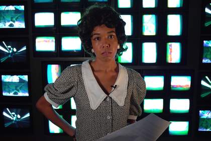 figure stood in front of television sets