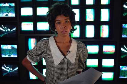 figure stood in front of television sets