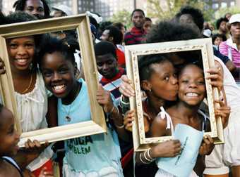 Girls posing in frames held up to their faces.