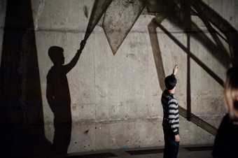 Young person taking part in a workshop in the Tanks at Hyperlink Festival, Tate Modern, 2013