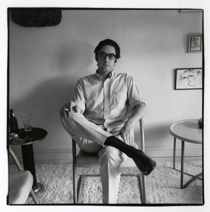 Photo of Walter Hopps sitting in a chair