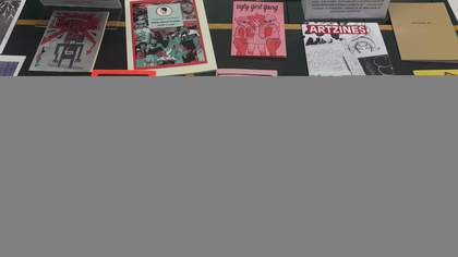Glass case filled with zines