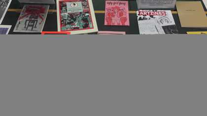 Glass case filled with zines