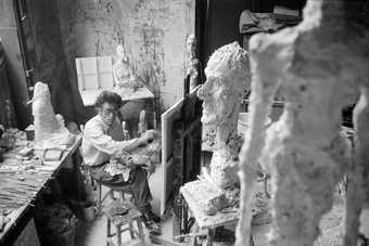 Giacometti painting in his Paris studio, in the foreground "La Grande Tête", 1958