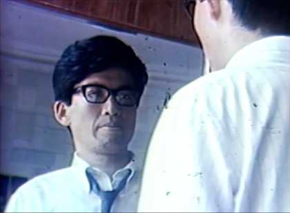 A man looks at his reflection in a mirror