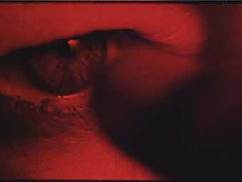 Still from the film Charlotte showing a red eye