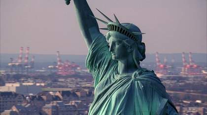 Still from the film 'Static' by Steve McQueen showing a close up of the head and raised arm of the statue of liberty.
