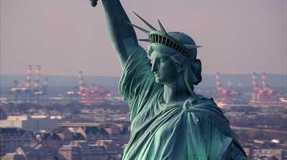 Still from the film 'Static' by Steve McQueen showing a close up of the head and raised arm of the statue of liberty.