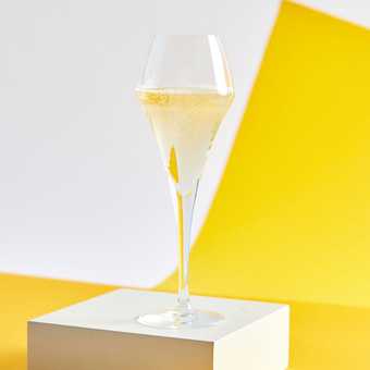 A photograph of a glass of sparkling wine