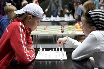 Two young people playing chess at Tate Modern