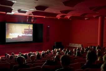 Local residents watching a film screening