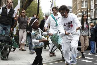 Local residents lead a parade through Southwark