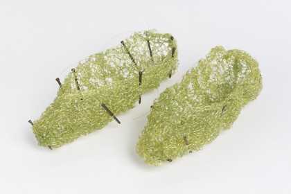 two little green knitted shoes