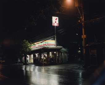 Photograph taken at night of a Seven Eleven shop