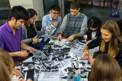 People gathered around a table doing arts and crafts
