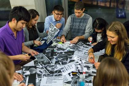People gathered around a table doing arts and crafts