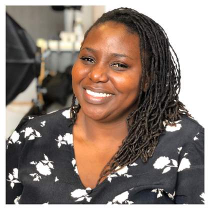 Portrait of Moud Goba wearing a black shirt with white flowers