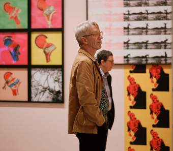 Two visitors viewing the Outi Pieski exhibition