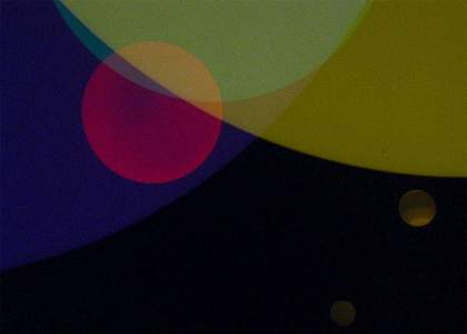 film still from 99 Clerkenwell Road, coloured circles overlapped on a black background