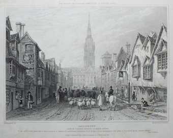 A black and white print of a bustling street scene featuring a road in the centre occupied by figures, horses and a flock of sheep, with buildings either side and Salisbury Cathedral’s spire in the background.