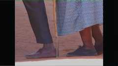 A close up of two people's feet as they walk