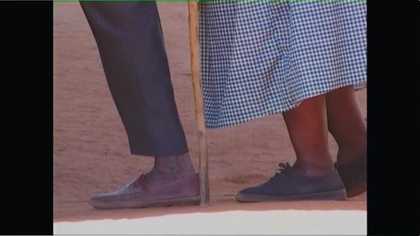 A close up of two people's feet as they walk