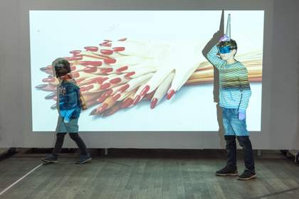Photograph of two children in front of a projector