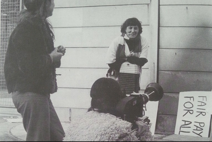 Black and white image of women in a doorway and some protest placards.
