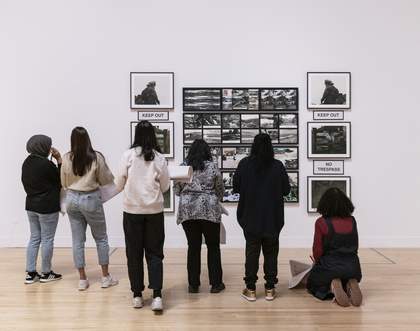 A group of teachers looking at an artwork in the gallery
