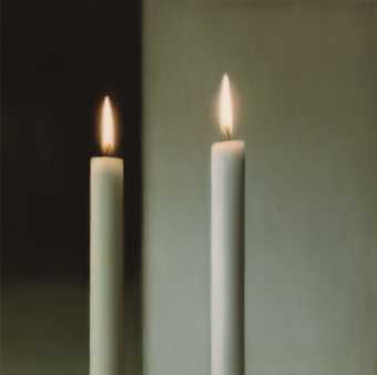 Two candles lit against a plain white background