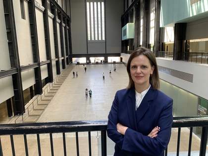Interim Director of Tate Modern, Catherine Wood standing in the Turbine Hall of Tate Modern